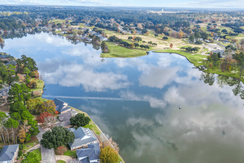 Professional drone photograph showing a residential property and its surrounding landscape.