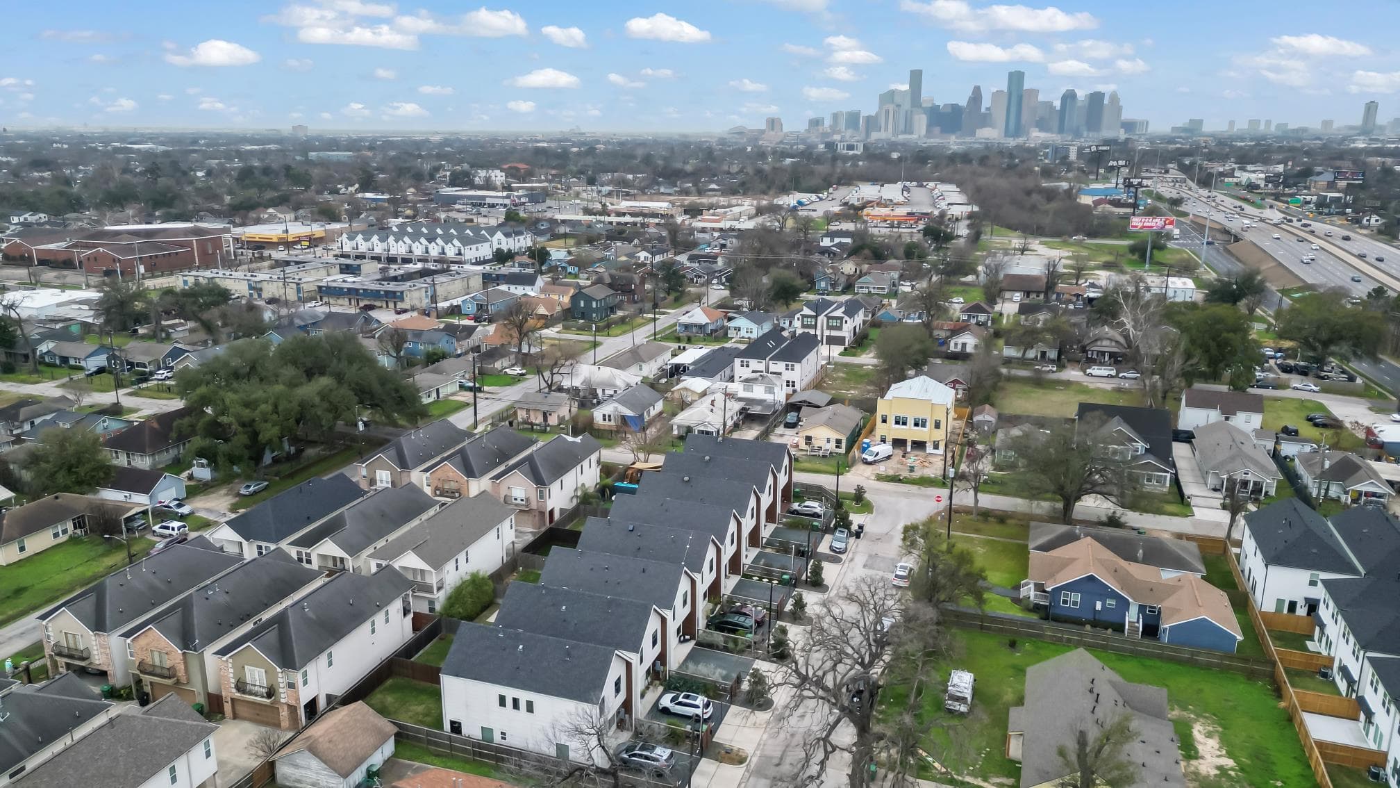 Aerial photograph showing the Fisk Street development and downtown Houston skyline.