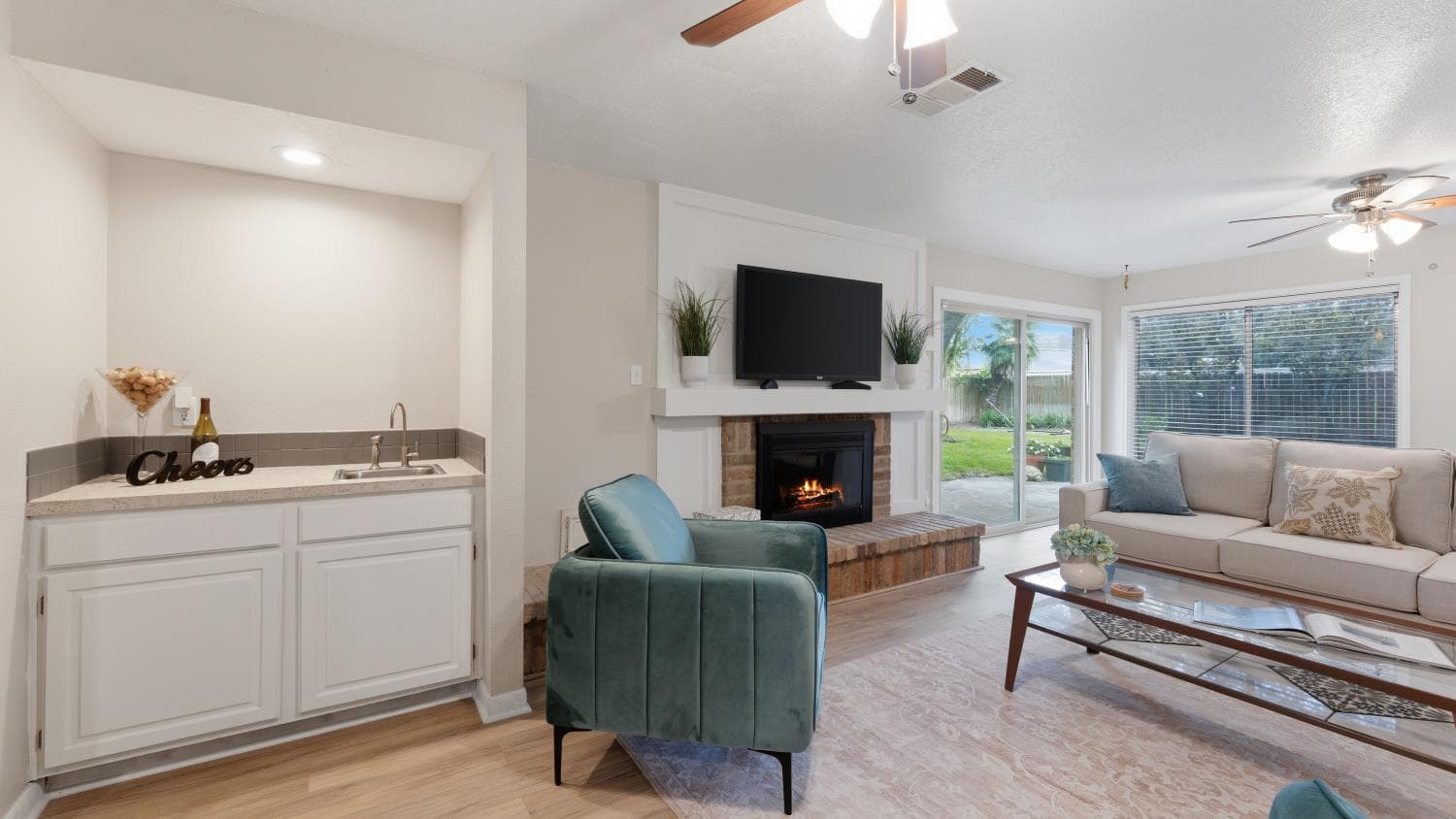 Houston home living room with fireplace and windows at 9915 Gold Cup Way.