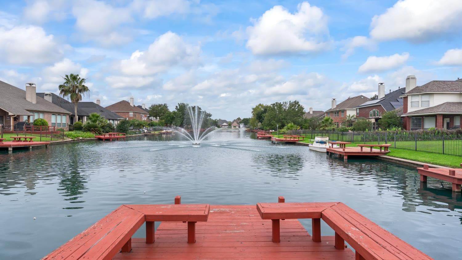 Ground-level view across the landscaped community water feature near Gold Cup Way.